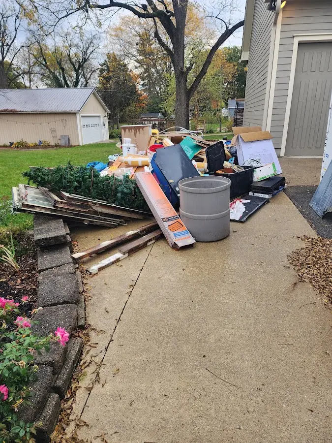 Dumpster being loaded with debris for Commercial Dumpster Rental in University Park